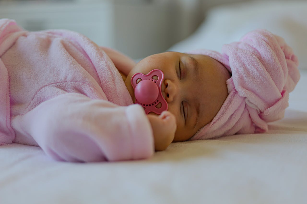 Newborn baby sleeping peacefully wrapped in a breathable, hypoallergenic cotton baby blanket.