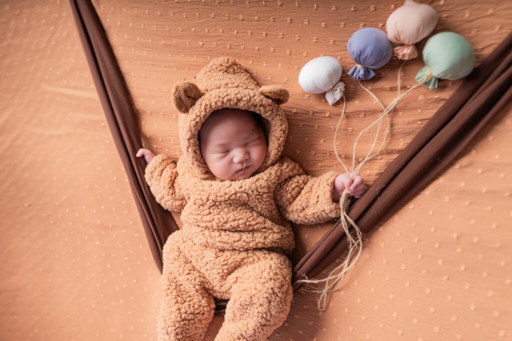 A parent folding a lightweight cotton baby blanket, showcasing easy care and maintenance.